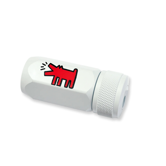 White cylindrical pencil sharpener with a red abstract design on a white background