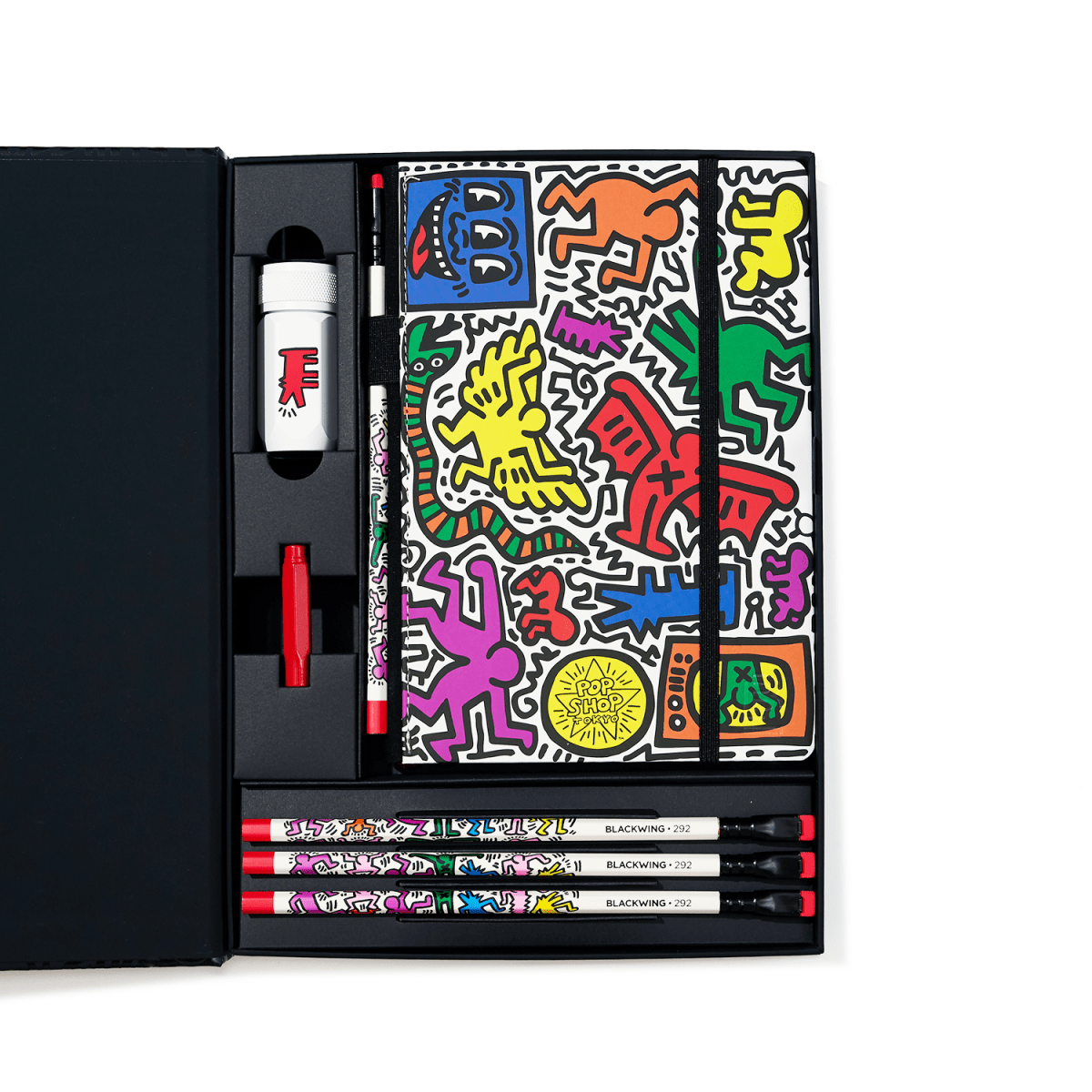 Colorful art supply set with a Keith Haring design on a white background