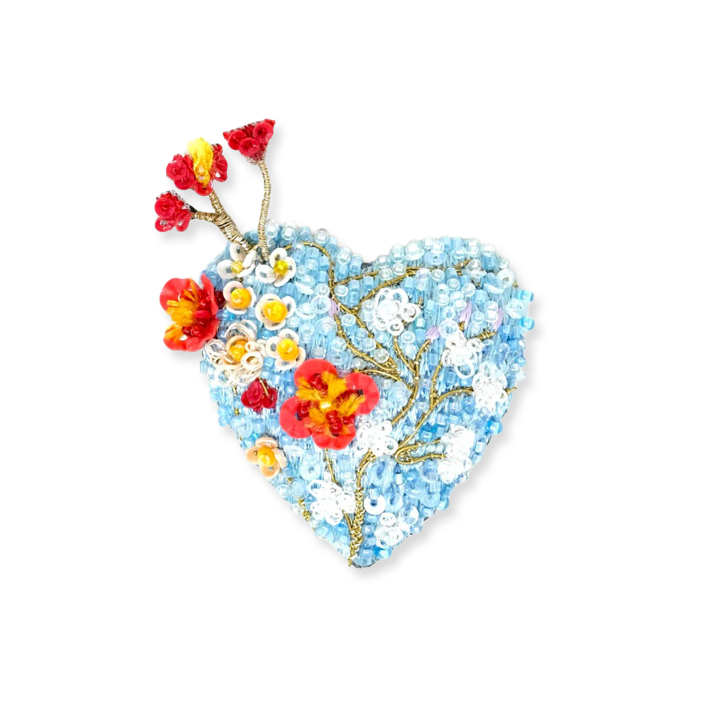 Heart-shaped brooch with floral design on a white background