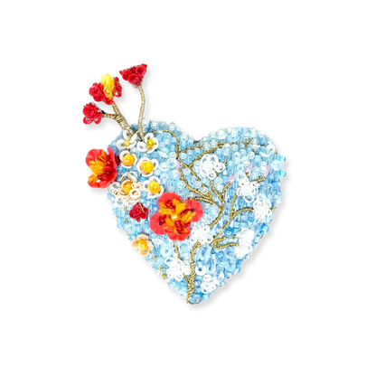Heart-shaped brooch with floral design on a white background