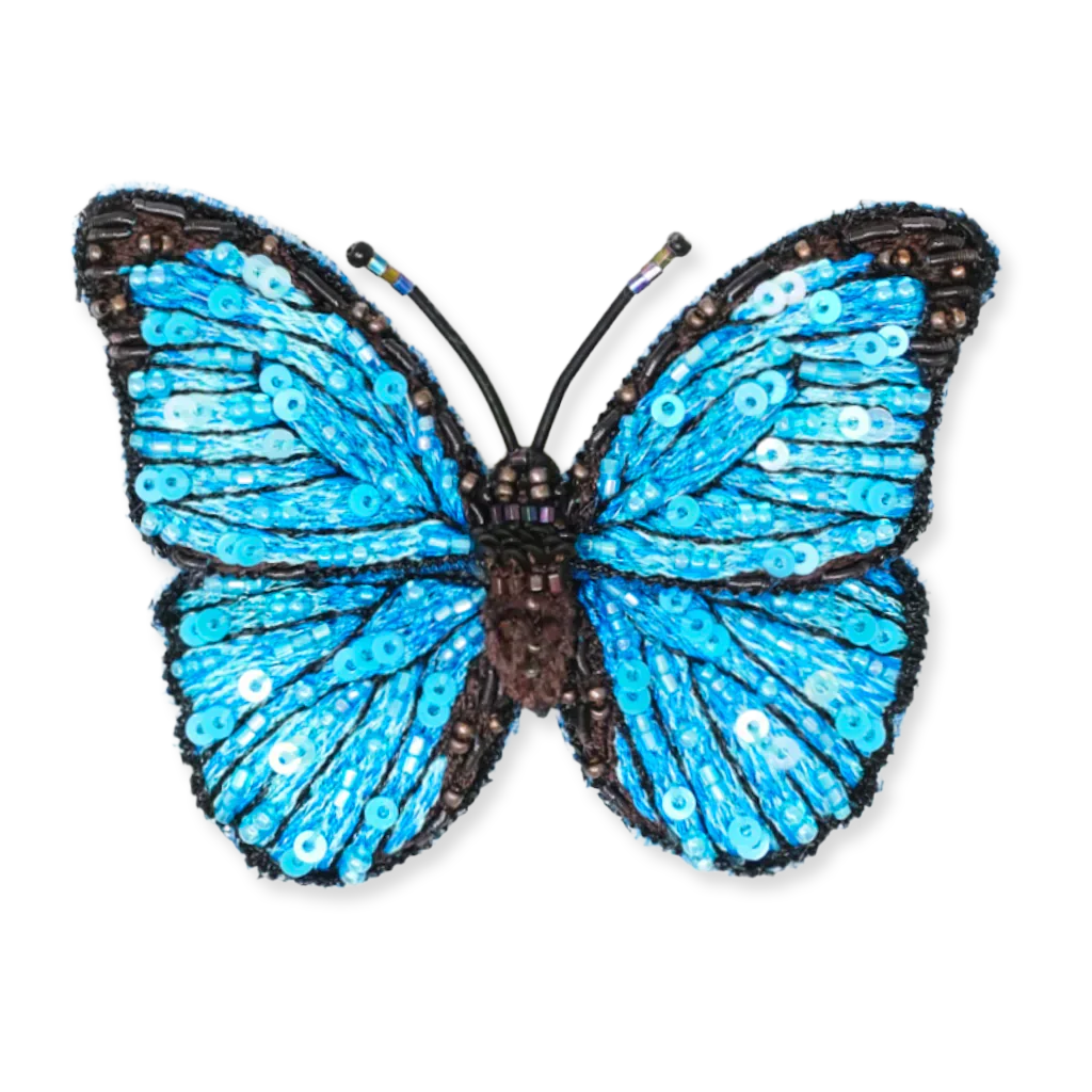 Decorative butterfly with blue wings and black body on a white background