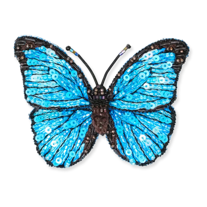 Decorative butterfly with blue wings and black body on a white background