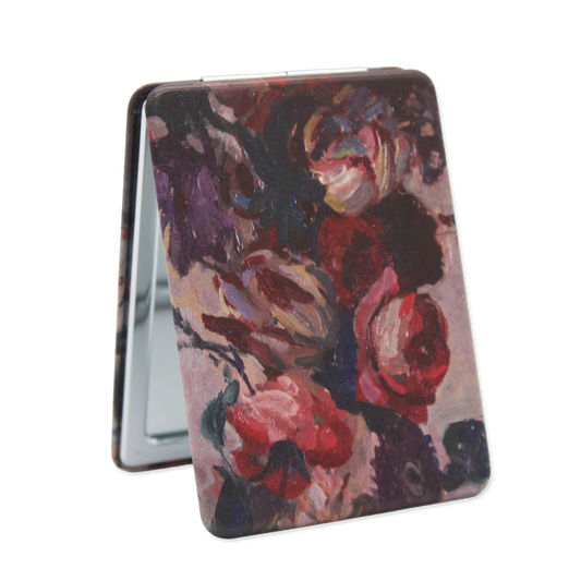 Floral patterned compact mirror on a white background