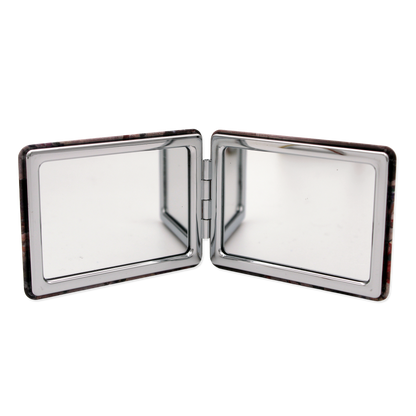 Compact mirror with two reflective surfaces on a white background