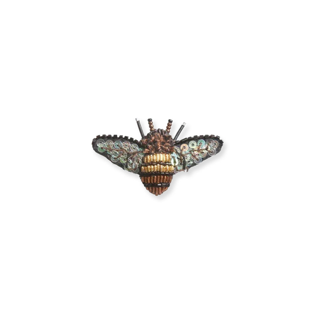 Decorative brooch resembling a bee on a white background
