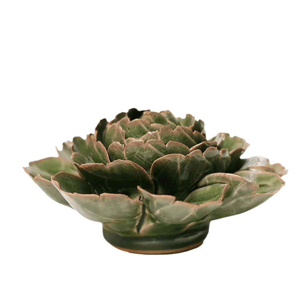 Green ceramic artichoke-shaped bowl on a white background