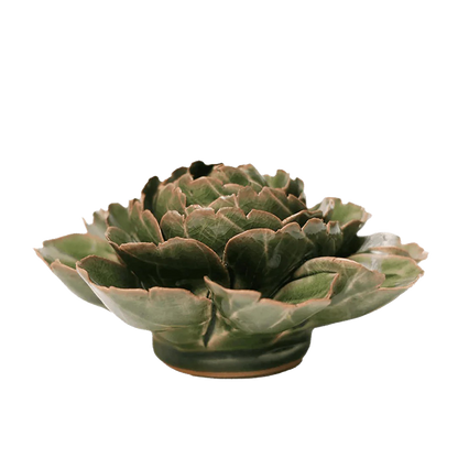 Green ceramic artichoke-shaped bowl on a white background