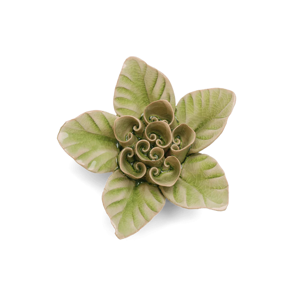 Decorative ceramic flower with green and beige pattern on a white background