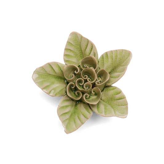 Decorative ceramic flower with green and beige pattern on a white background