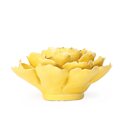 Yellow ceramic artichoke-shaped object on a white background