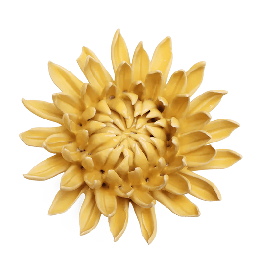 Yellow ceramic sunflower wall art on a white background
