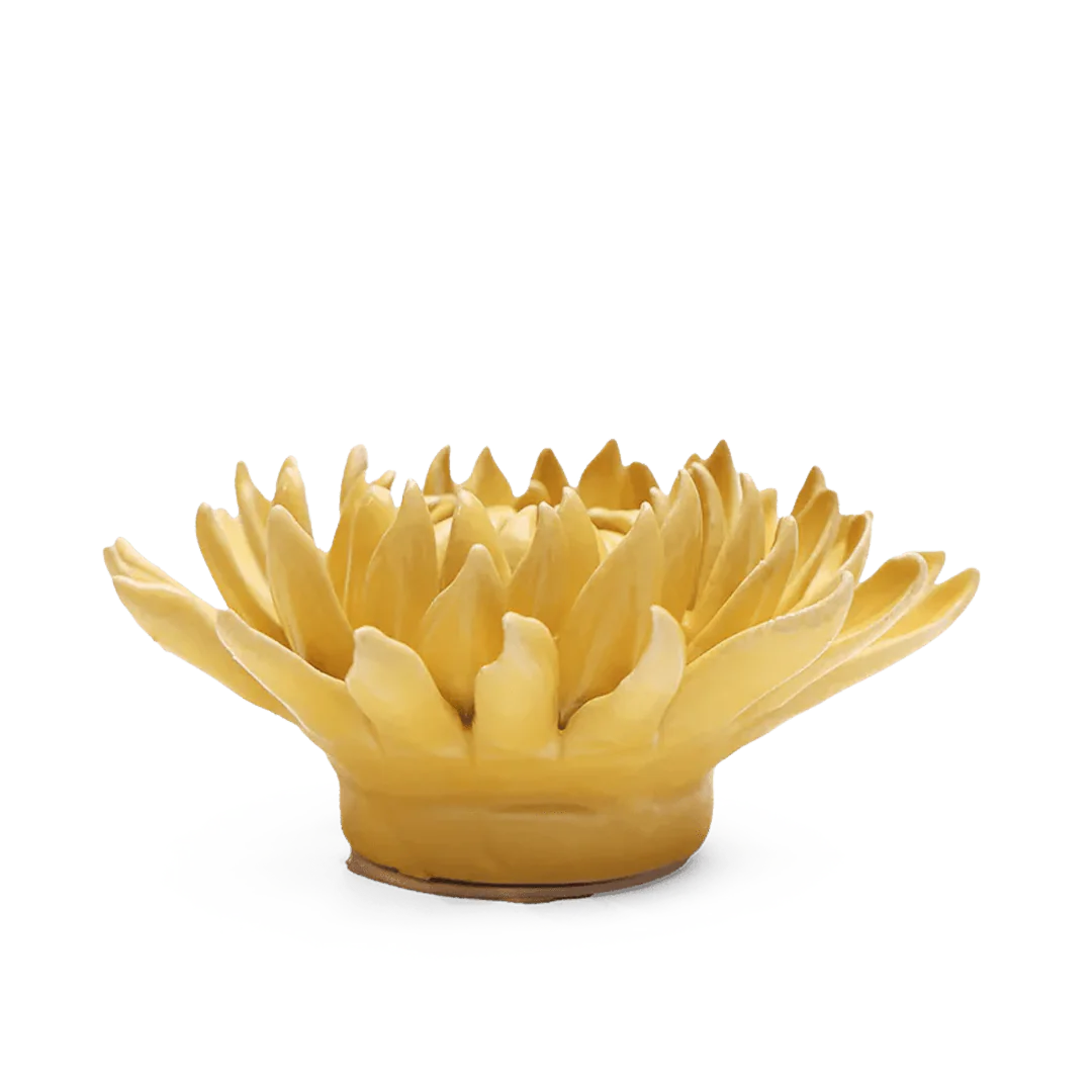 Yellow ceramic flower-shaped bowl on a white background