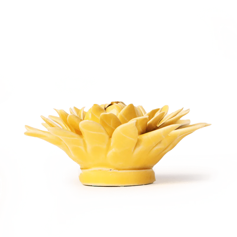 Yellow ceramic pineapple-shaped object on a white background