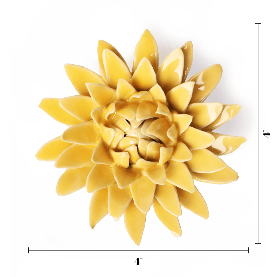 Yellow ceramic wall art piece resembling a flower on a white background