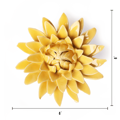 Yellow ceramic wall art piece resembling a flower on a white background