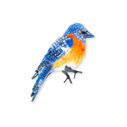 Decorative bird figurine with blue, orange, and gray colors on a white background