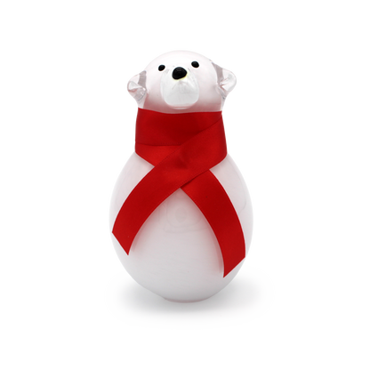 White polar bear figurine with a red ribbon on a white background