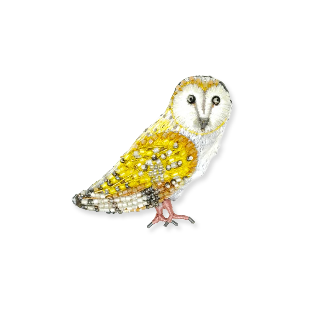 Decorative owl figurine with yellow and white colors on a white background