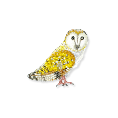 Decorative owl figurine with yellow and white colors on a white background
