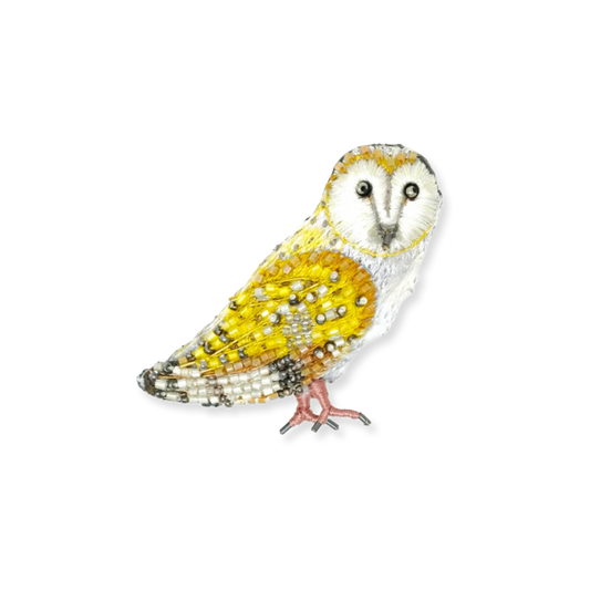 Decorative owl figurine with yellow and white colors on a white background