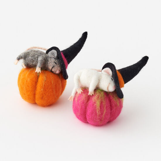 Two small felt pumpkins with mice wearing witch hats on a white background
