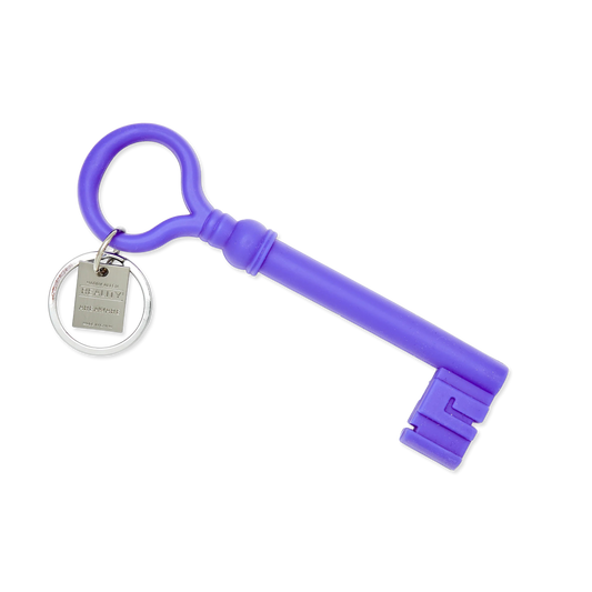 Purple key-shaped keychain on a white background