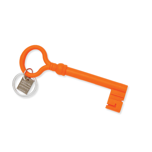 Orange key-shaped keychain with a silver tag on a white background