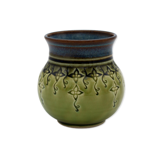 Green ceramic vase with decorative patterns on a white background