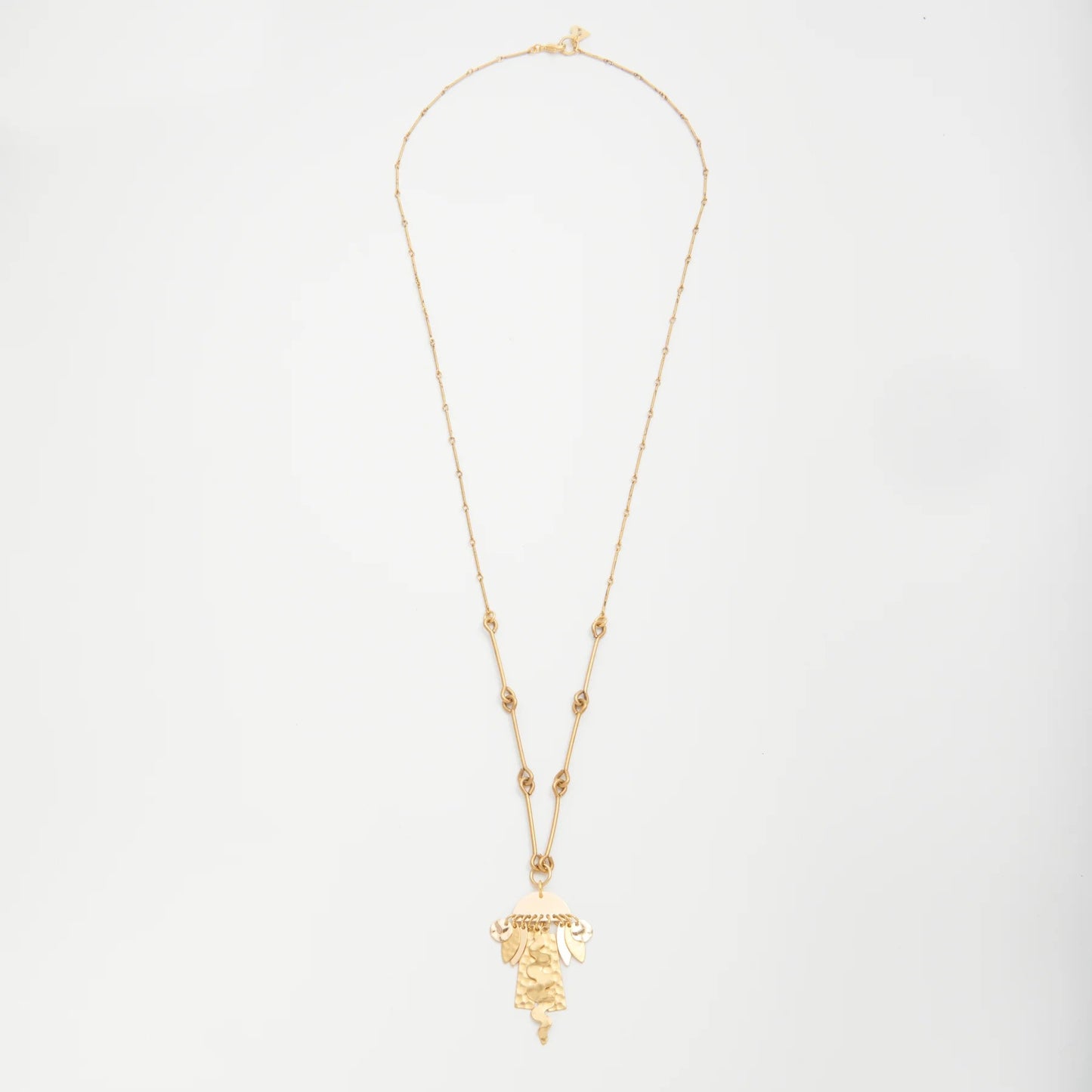 Gold necklace with a pendant on a light gray background