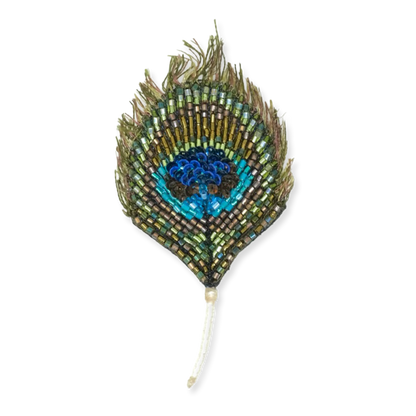Decorative peacock feather with beads on a white background