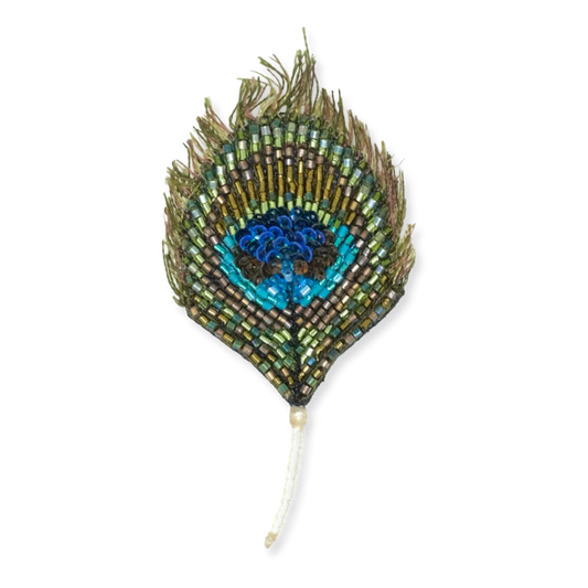 Decorative peacock feather with beads on a white background