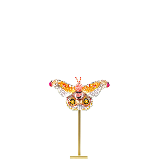 Decorative butterfly sculpture on a stand with a white background