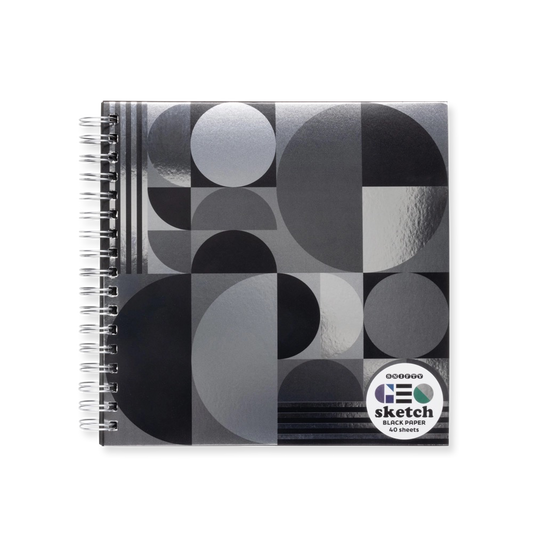 Spiral-bound sketchbook with geometric metallic black and gray circle pattern on a white background