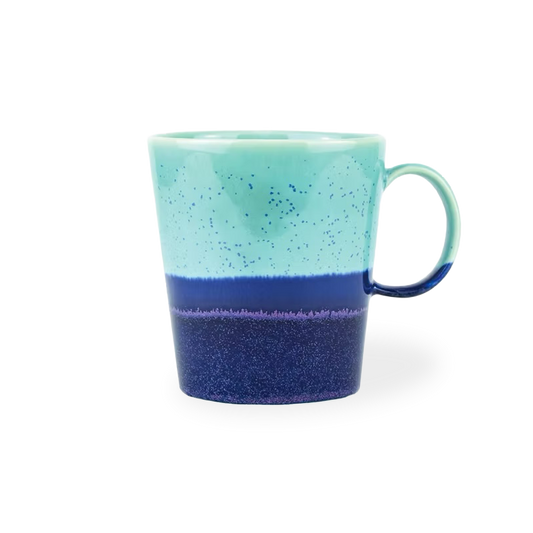 Turquoise and blue ceramic mug on a white background