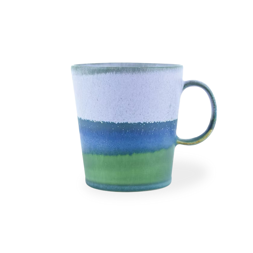 Ceramic mug with blue and green gradient on a white background