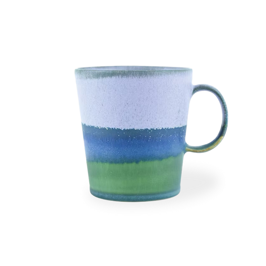 Ceramic mug with blue and green gradient on a white background