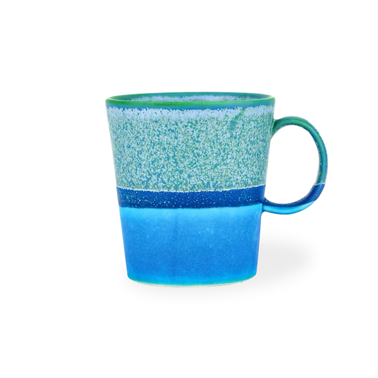 Blue ceramic mug with a speckled pattern on a white background