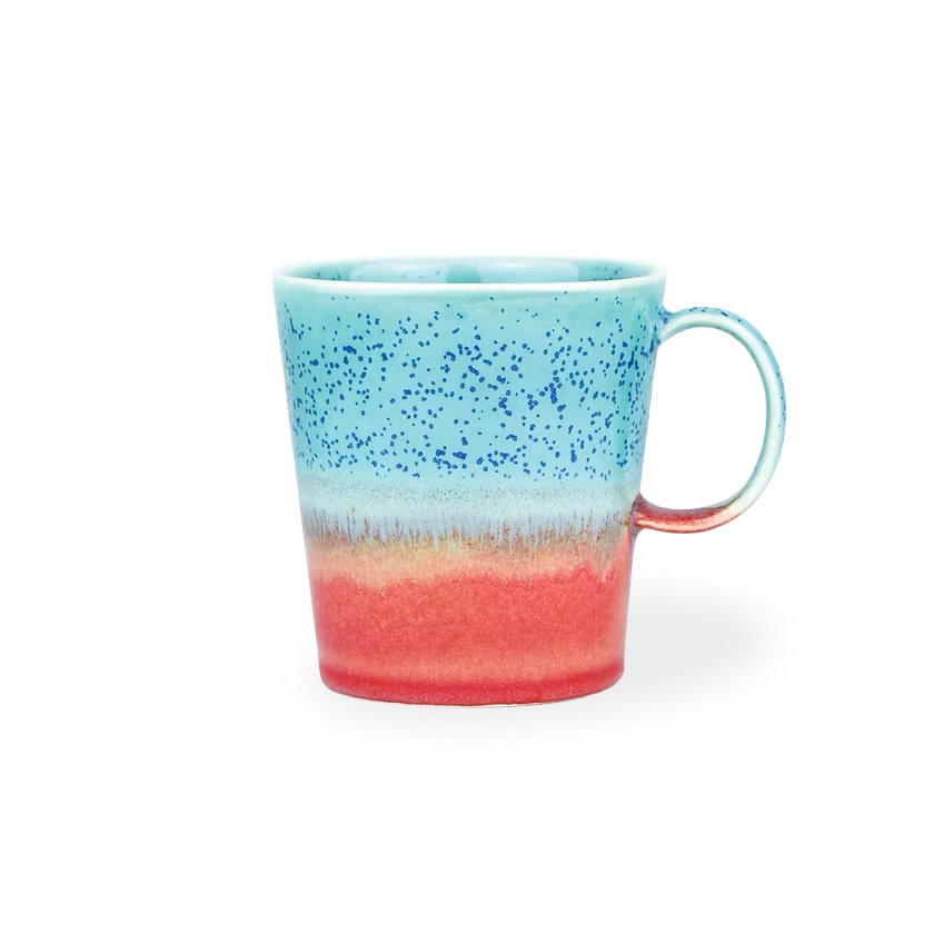 Speckled mug with blue top and red bottom on a white background