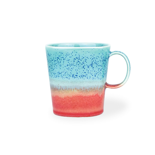 Speckled mug with blue top and red bottom on a white background