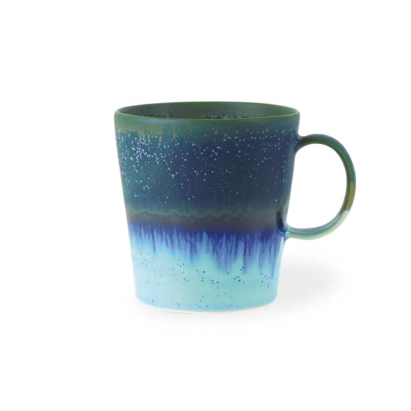 Blue and green mug with gradient design on a white background