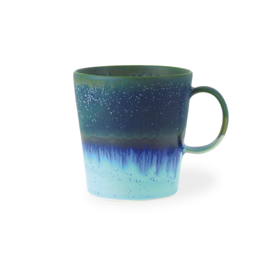 Blue and green mug with gradient design on a white background