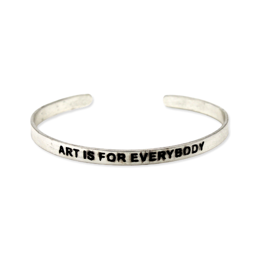 Silver cuff with the motto "Art is for everybody"