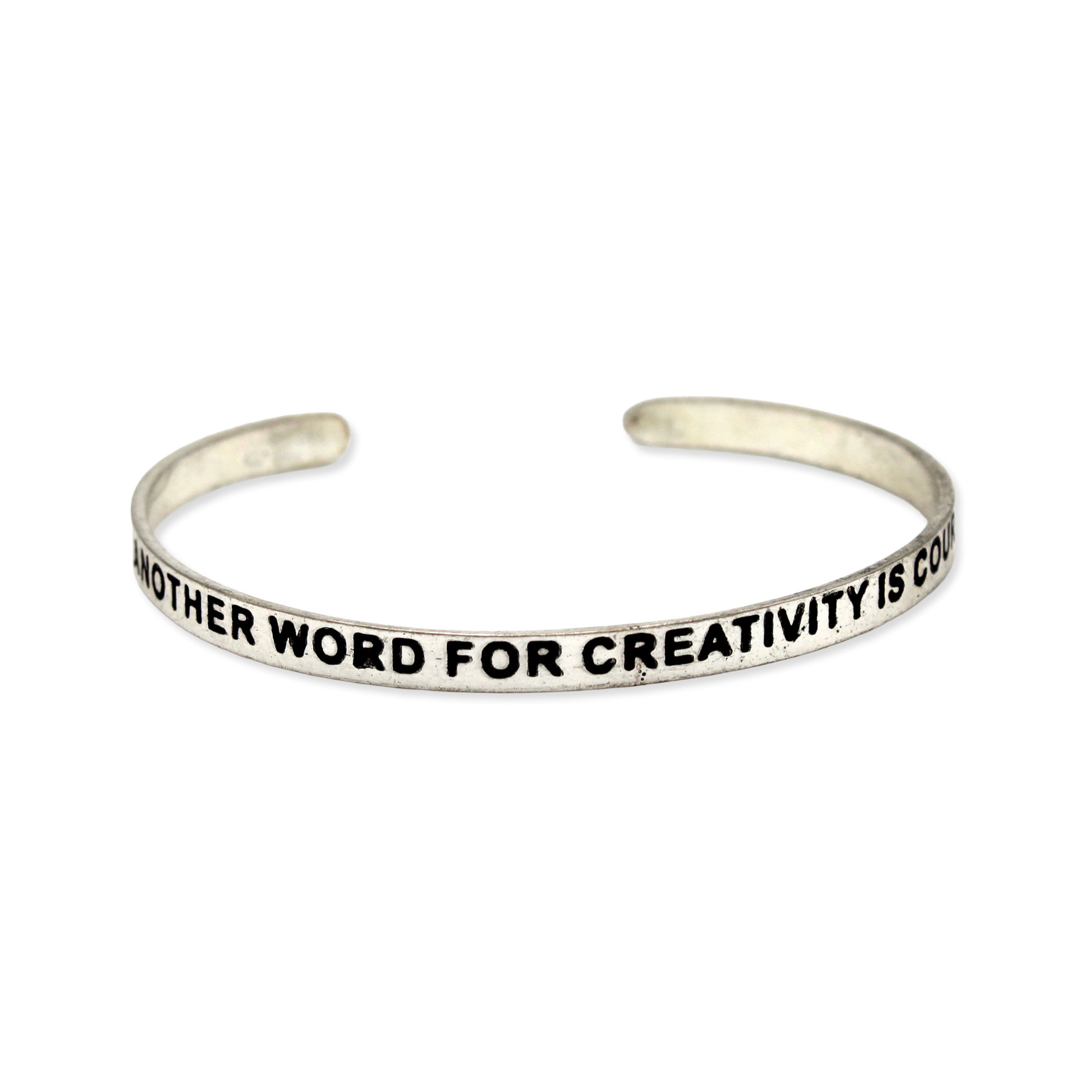 Silver cuff with the motto "Another word for creativity is courage"