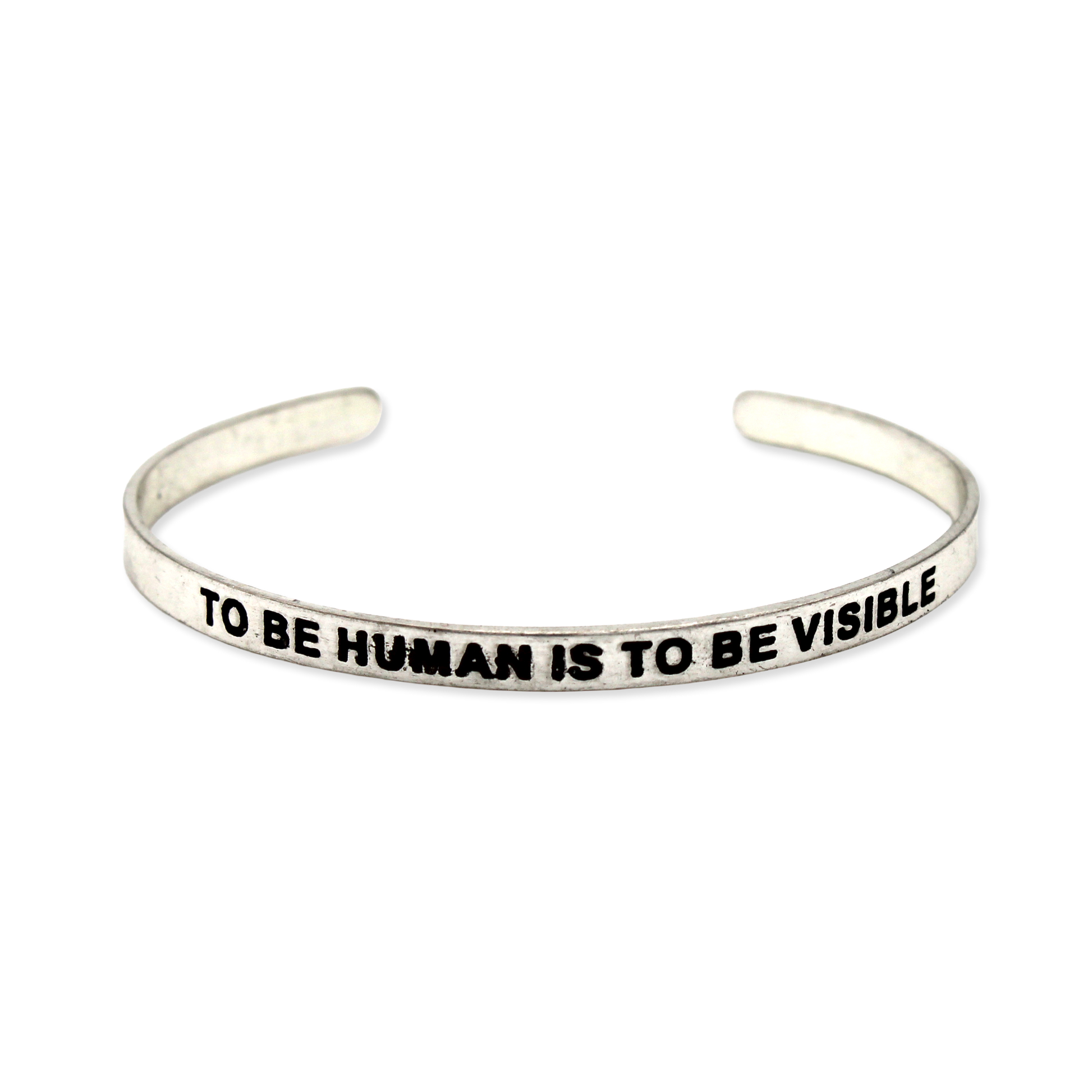 Silver cuff with the motto "To be human is to be visible."