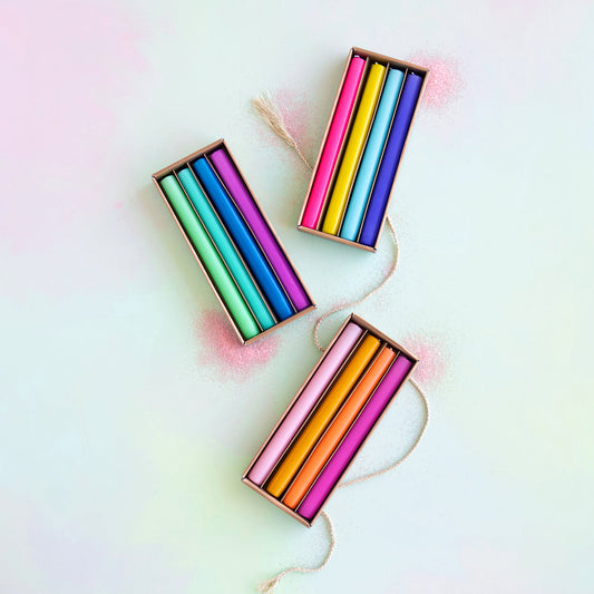 Three boxes of colorful crayons on a light background