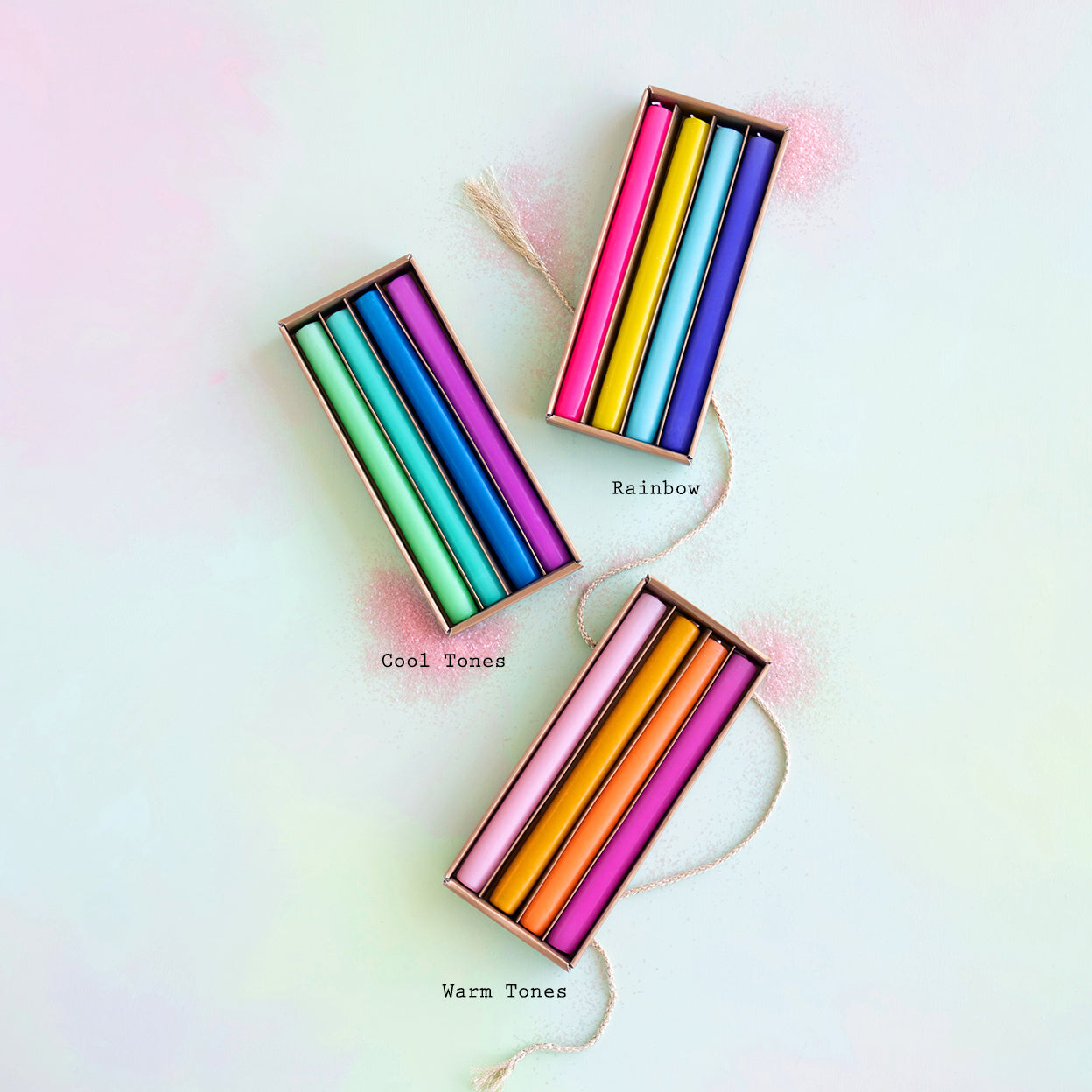 Three boxes of colorful crayons labeled 'Rainbow', 'Cool Tones', 'Warm Tones' on a light background.