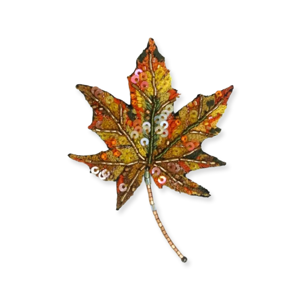 Decorative leaf with sequins on a white background