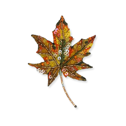 Decorative leaf with sequins on a white background