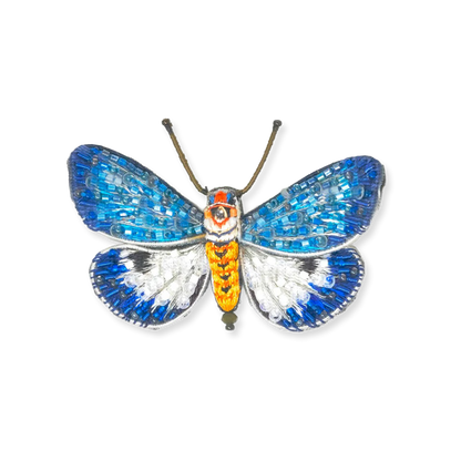 Butterfly-shaped decorative item with blue, orange, and silver colors on a white background