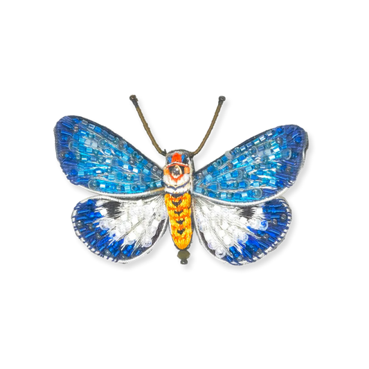 Butterfly-shaped decorative item with blue, orange, and silver colors on a white background